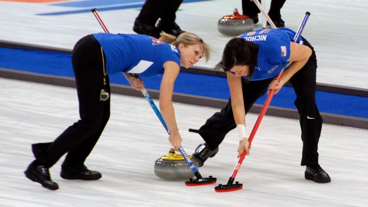 Which sport, played on ice with polished heavy stones, is